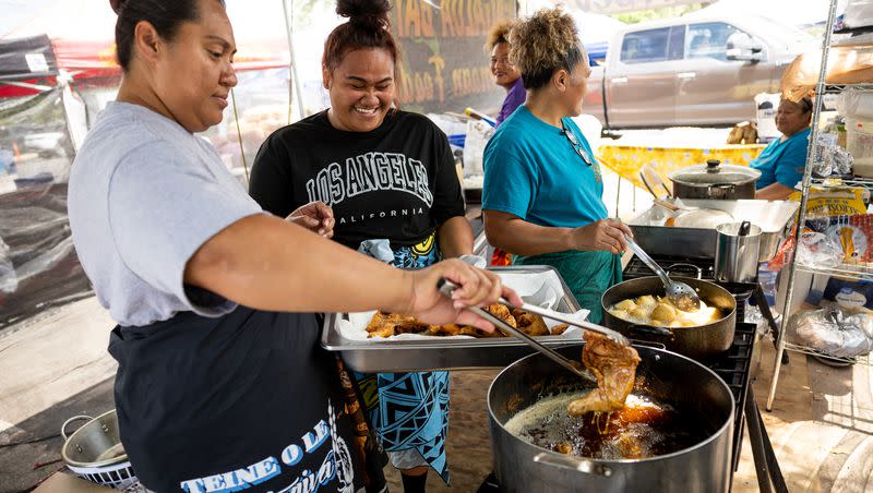 Folesi Lefaoseu, Marjorie Sua and Avao Lagi cook at Fagaloa Bay Samoan Food’s stand at the second annual Samoan Heritage Festival in Kearns on Wednesday, July 19, 2023.