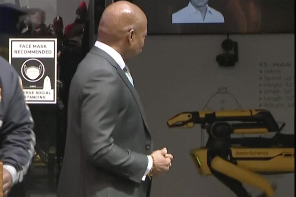 This image taken from video provided by New York City Office of The Mayor, New York Mayor Eric Adams looks back at Digidog mobile robot, during a news conference in Times Square on Tuesday, April 11, 2023 in New York. New York City officials unveiled three new high-tech policing devices Tuesday, including Digidog, that critics called creepy when it first joined the police pack 2 1/2 years ago. (New York City Office of The Mayor via AP)