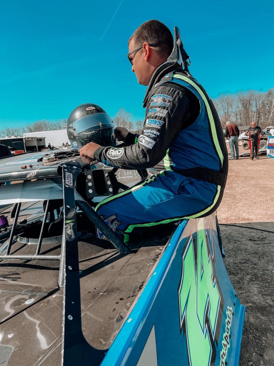 Bedford Late Model driver Britan Godsey climbs into the cockpit prior to a recent race at Brownstown Speedway.