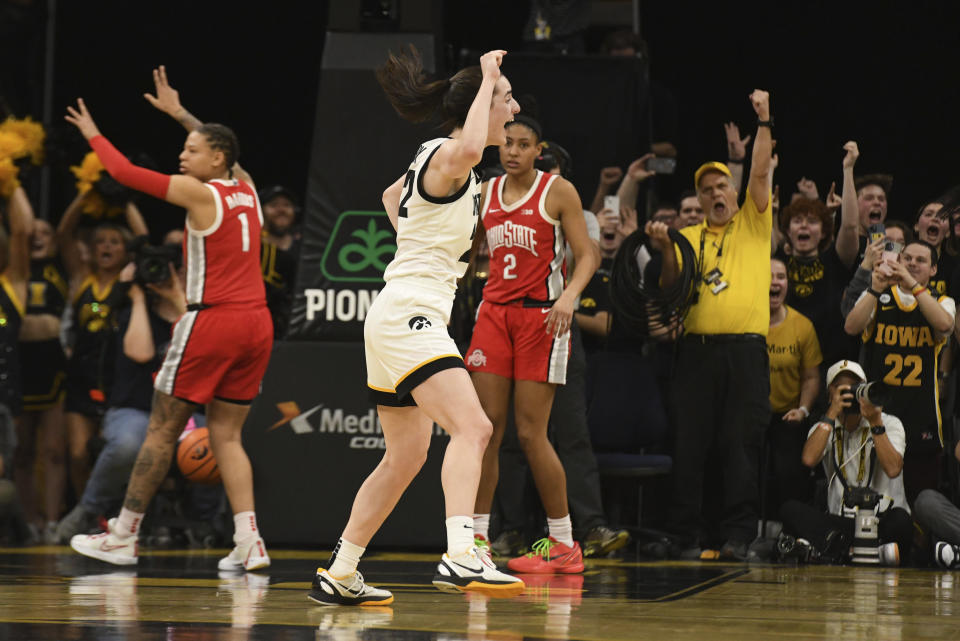 Iowa guard Caitlin Clark, second from left, celebrates after sinking a foul shot against Ohio State to become the all-time leading scorer in NCAA Division I basketball during the first half of a college game, Sunday, March 3, 2024, in Iowa City, Iowa. (AP Photo/Cliff Jette)