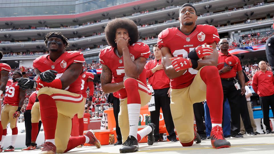 San Francisco 49ers players Eli Harold, left, Colin Kaepernick and Eric Reid kneel during the national anthem before an NFL game in Santa Clara, California, on October 2, 2016. - Marcio Jose Sanchez/AP/FILE