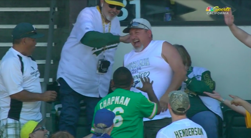 An Athletics fan grabbed two foul balls on two consecutive pitches. (Screenshot via MLB.com)