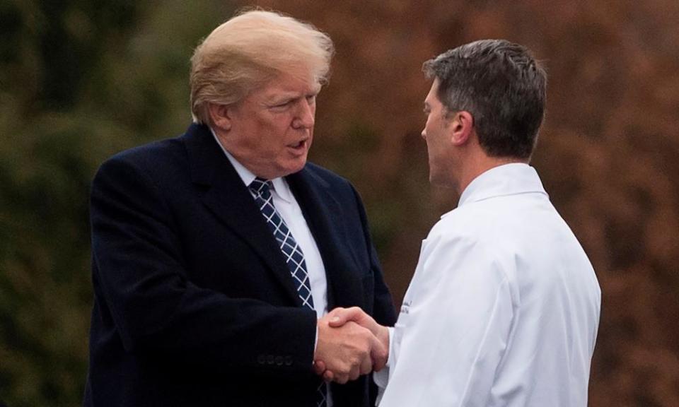 Donald Trump shakes hands with White House physician Rear Admiral Dr Ronny Jackson following his medical at Walter Reed National Military Medical Center in Bethesda, Maryland