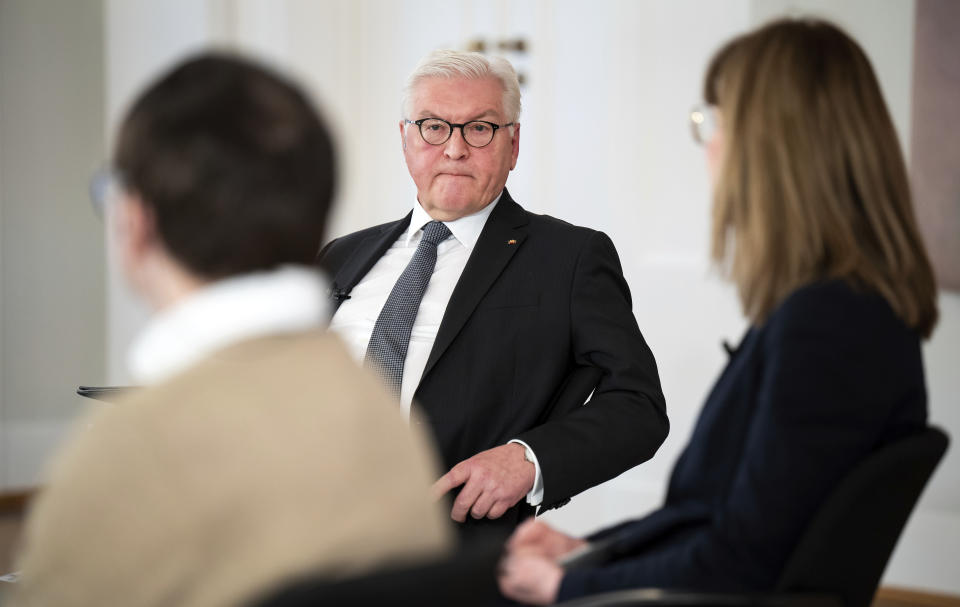 German President Frank-Walter Steinmeier, center. attends a discussion about the pros and cons of mandatory vaccination to overcome the Covid 19 pandemic in Germany with guests, as well as digitally connected participants, at Bellevue Palace in Berlin, Germany, Wednesday, Jan. 12, 2022. (Bernd von Jutrczenka/dpa via AP)