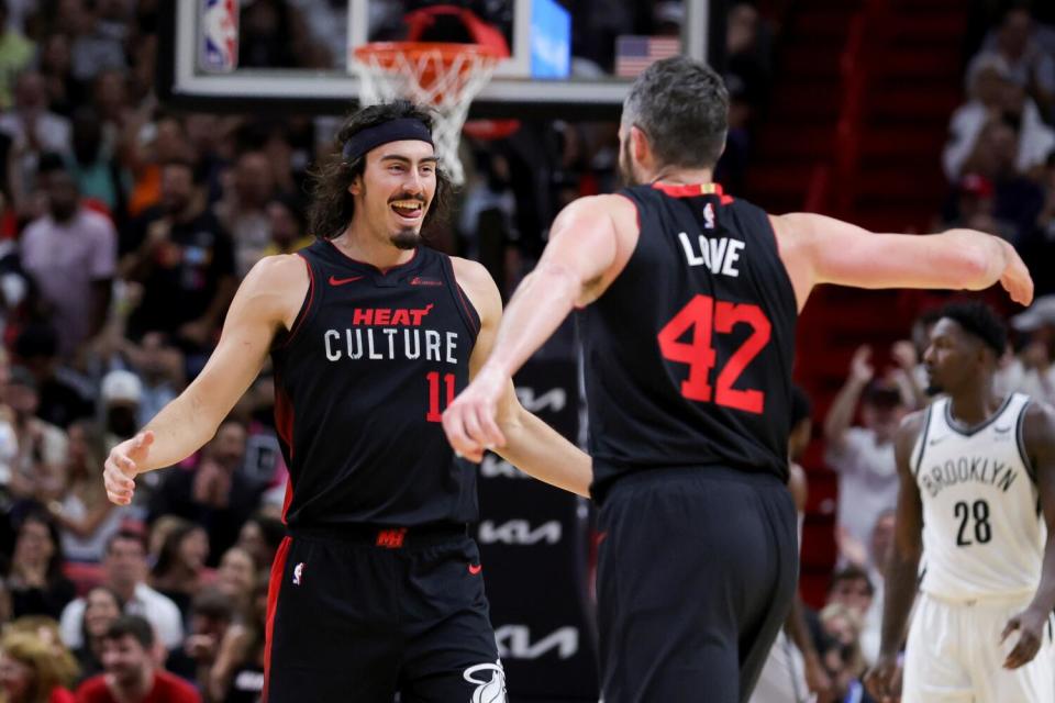 Jaime Jaquez Jr. and Kevin Love clap hands during the Heat's game against the Nets on Nov. 16.