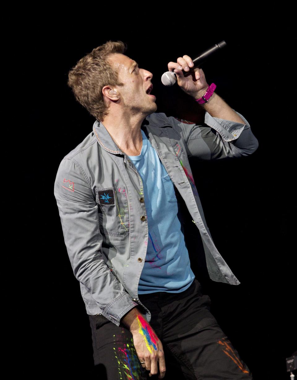 FILE - This April 17, 2012 file photo shows Chris Martin, lead singer of Coldplay, performing in Edmonton, Alberta, Canada. Coldplay will perform at the iTunes music festival during the South by Southwest festival in Austin, Texas. It will mark the U.S. debut of its popular iTunes Festival, a free concert series has been held for the past seven years in London. (AP Photo/The Canadian Press, Jason Franson, File)