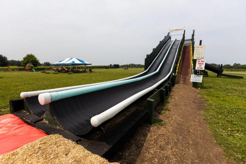 A 90-foot, custom-built, dual-mat slide called Larry’s Lightning is behind the country store at Eckert’s Orchard in Versailles. Playgrounds have become an addition to the orchard experience in recent years.