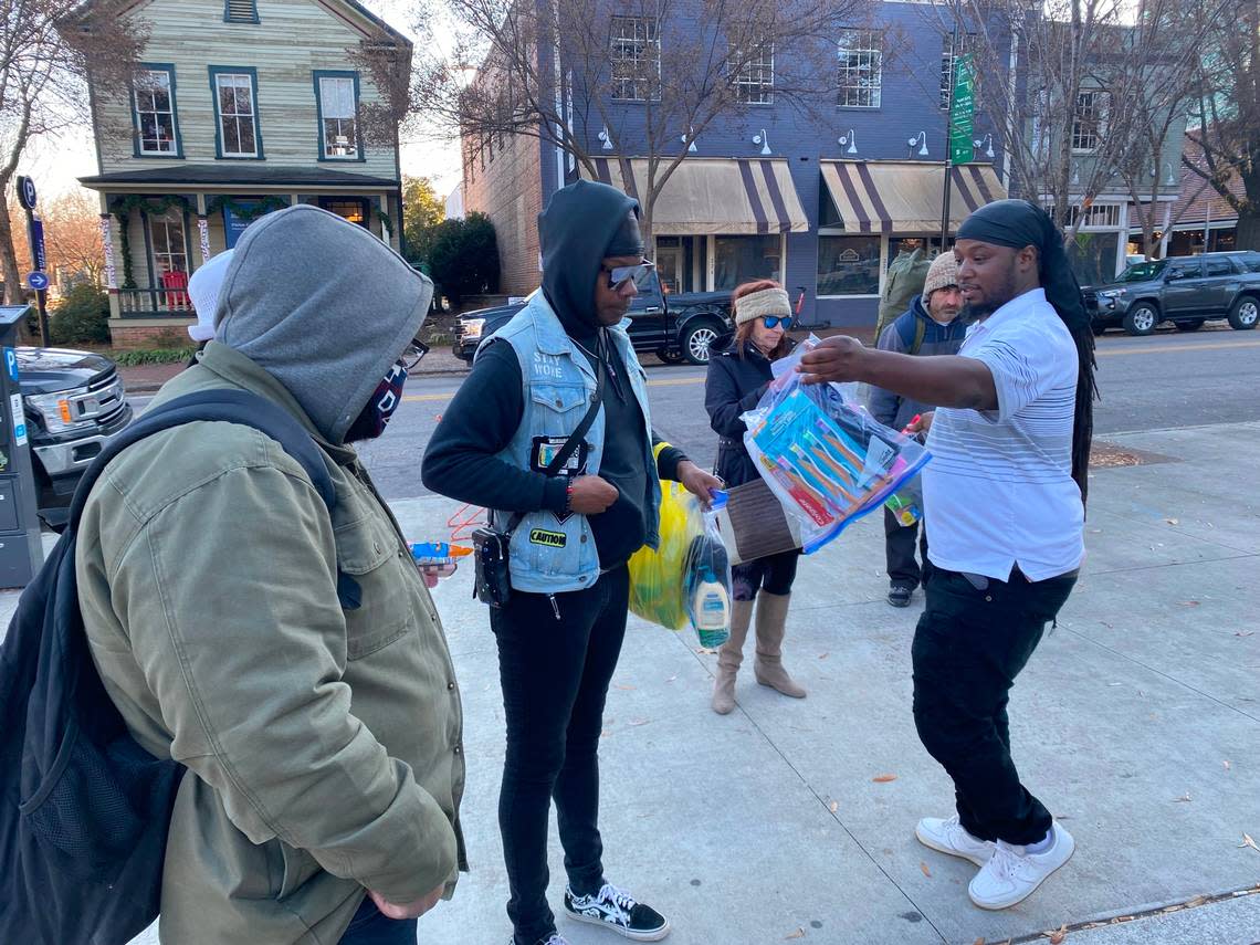 Brandon Anderson, 35, hands out a hygeine kit in Moore Square in downtown Raleigh Tuesday as part of his ongoing efforts to assist Raleigh’s homeless.