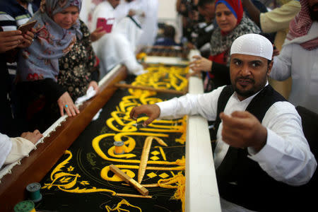 A man embroiders the Kiswa, a silk cloth covering the Holy Kaaba, ahead of the annual haj pilgrimage, at a factory in the holy city of Mecca, Saudi Arabia August 26, 2017. Picture taken August 26, 2017. REUTERS/Suhaib Salem