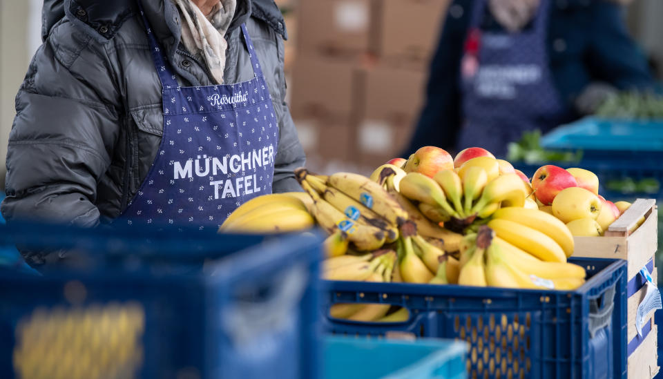 22 November 2019, Bavaria, Munich: Volunteers of the Münchner Tafel sort food for the guests at the issuing point at the wholesale market. At the approximately 170 tables in Bavaria, about 7000 mostly volunteer helpers distribute donated food to needy people. Photo: Sven Hoppe/dpa (Photo by Sven Hoppe/picture alliance via Getty Images)