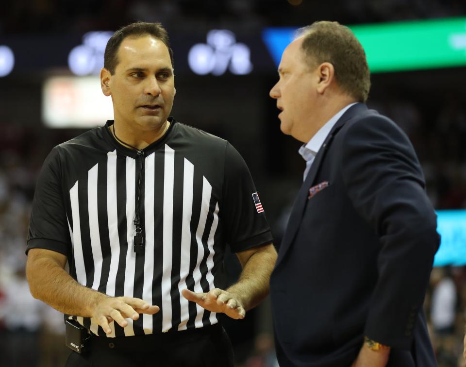 Nov 17, 2019; Madison, WI, USA; Wisconsin Badgers head coach Greg Gard talks with NCAA referee Bo Boroski during the game with the Marquette Golden Eagles at the Kohl Center.