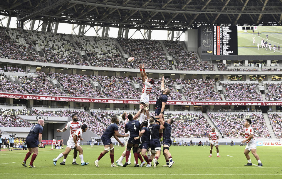 Players of Japanese and England's teams vie for the ball during a rugby test match in Tokyo, Japan, Saturday, June 22, 2024. England's stop in Tokyo on its way to a two-test rugby tour of New Zealand was no contest as the visitors beat Japan 52-17 Saturday in an eight-try performance at the National Stadium in Tokyo. (Kyodo News via AP)