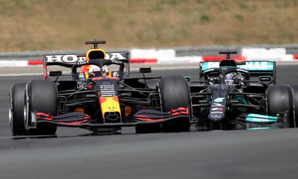 Max Verstappen and Lewis Hamilton in action at the end of the race.