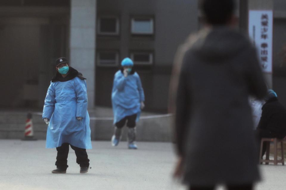 Security personnel wearing masks seen at the Jinyintan hospital in China (REUTERS)