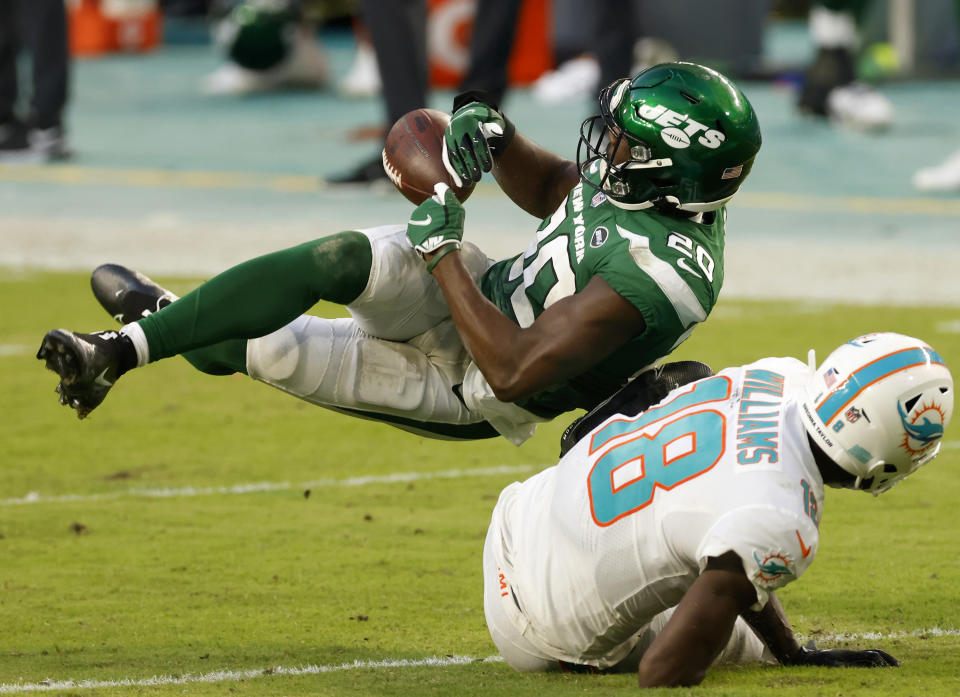 Marcus Maye grabs for the ball while falling to the ground.