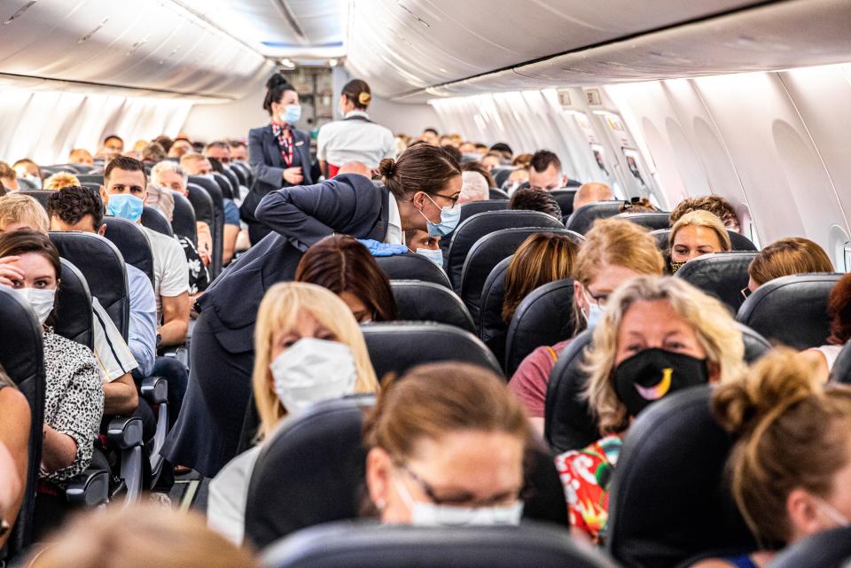 Passengers are welcomed on a Corendon plane departing from Amsterdam's Schiphol airport to Bulgaria's Burgas airport, on June 26, 2020, on the first holiday flight by the travel company since the novel coronavirus in March. (Photo by JEFFREY GROENEWEG/ANP/AFP via Getty Images)