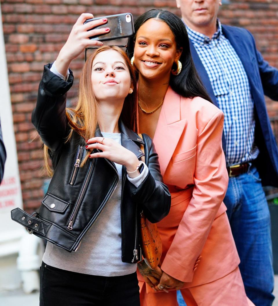 Rihanna stops to take a selfie with a fan as she runs errands in N.Y.C. on Wednesday.