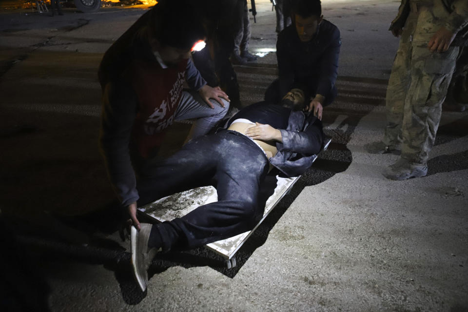 A man receives medical assistance after being injured in the latest earthquake in Hatay, Turkey, Monday, Feb. 20, 2023. A new 6.4 magnitude earthquake on Monday killed three people and injured more than 200 in parts of Turkey that were laid waste two weeks ago by a massive quake that killed tens of thousands. Officials said more buildings collapsed, trapping occupants, and several people were injured in both Turkey and Syria. (Efekan Akyuz/Depo Photos via AP)