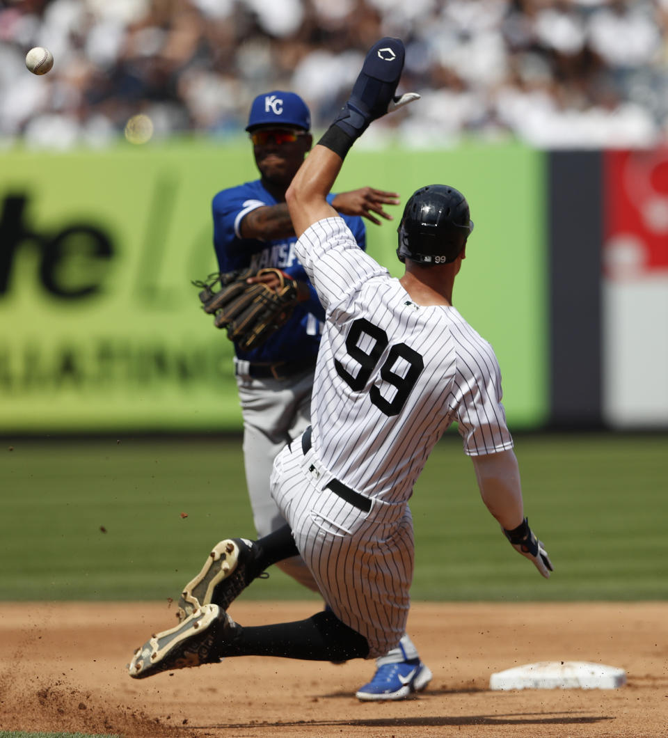 New York Yankees' Aaron Judge (99) is out as Kansas City Royals shortstop Maikel Garcia, left, throws to first base during the fourth inning of a baseball game Sunday, July 31, 2022, in New York. (AP Photo/Noah K. Murray)