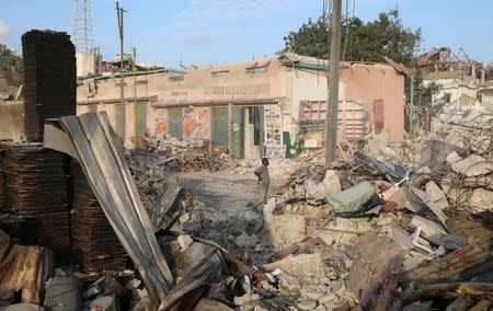 A Somali shop owner stands next to the ruins of his shop at the scene of last Saturday explosion in KM4 street in the Hodan district in Mogadishu, Somalia October 17, 2017. REUTERS/Feisal Omar