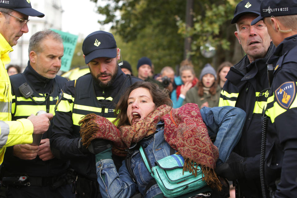 Dutch anti riot police arrested the Extinction Rebellion climate activists lie on the ground to perform a die-in action during Rebel Without Borders demonstration at the Museumbrug on Oct. 7, 2019 in Amsterdam,Netherlands. (Photo: Paulo Amorim/NurPhoto via Getty Images)