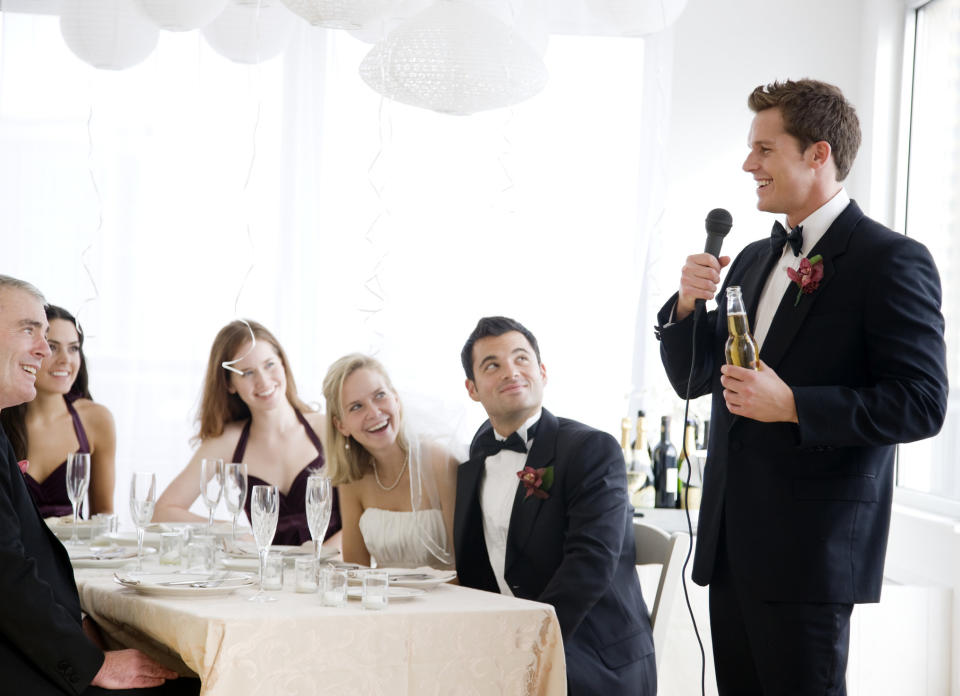 A man giving a speech at a wedding