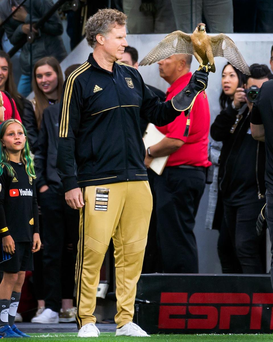 Will Ferrell in the only appropriate soccer game outfit—a tracksuit and a falcon.