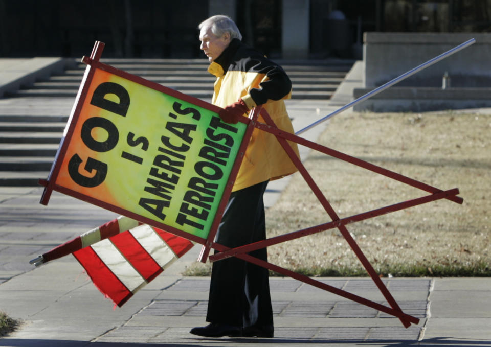 CORRECTS DATE OF DEATH TO WEDNESDAY, MARCH 19 INSTEAD OF THURSDAY MARCH 19 - FILE - In this July 1, 2007 file photo, the Rev. Fred Phelps Sr. prepares to protest outside the Kansas Statehouse in Topeka, Kan. Phelps, the founder of the Kansas church known for anti-gay protests and pickets at military funerals, died late Wednesday, March 19, 2014, his family said. He was 84. (AP Photo/Orlin Wagner, File)