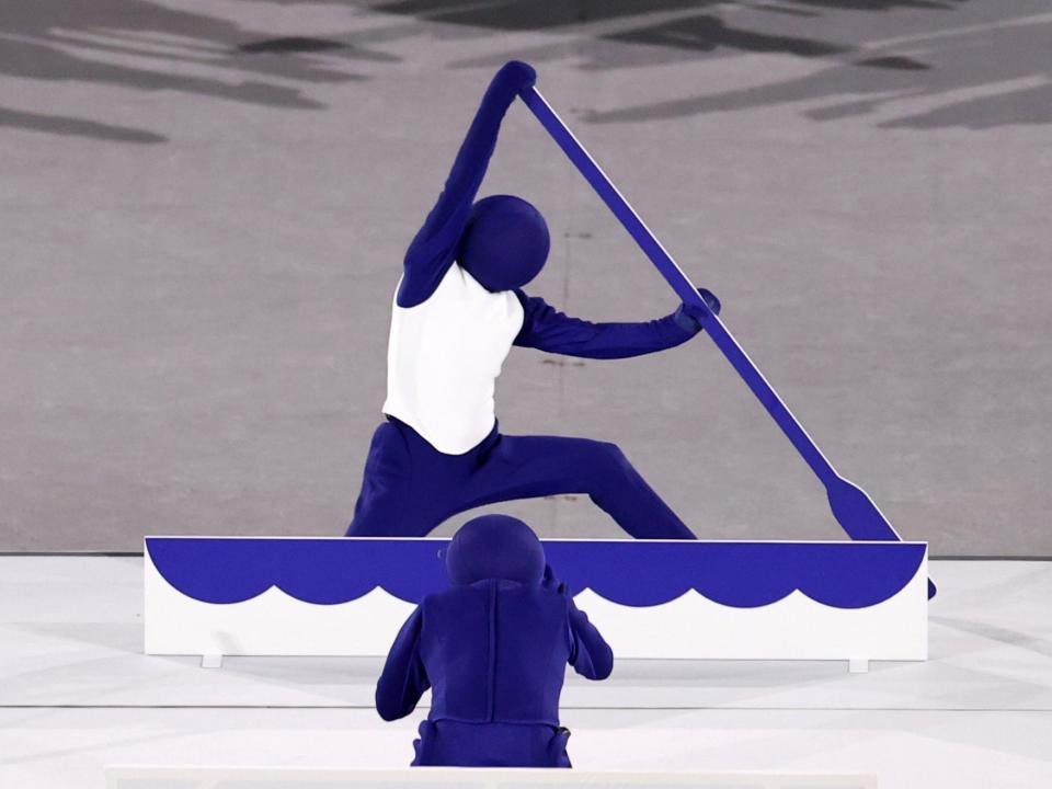 performers recreating sport pictograms at the opening ceremony 2021