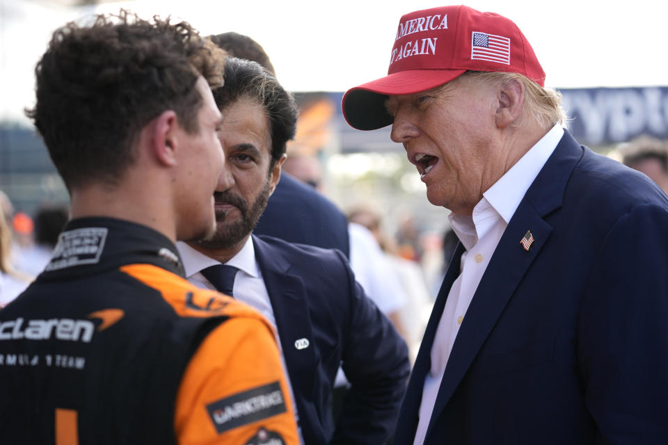 Republican presidential candidate former President Donald Trump, right, talks with McLaren driver Lando Norris, left, of Britain, after Norris won the Miami Formula One Grand Prix auto race Sunday, May 5, 2024, in Miami Gardens, Fla. (AP Photo/Rebecca Blackwell)