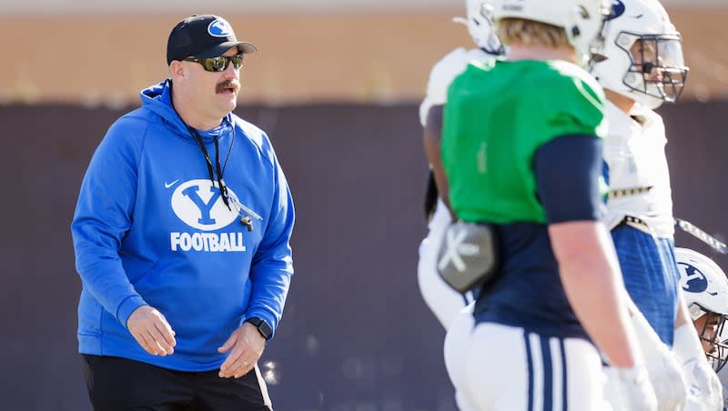 New BYU offensive line coach TJ Woods works with players during spring camp in Provo on March 16, 2024.