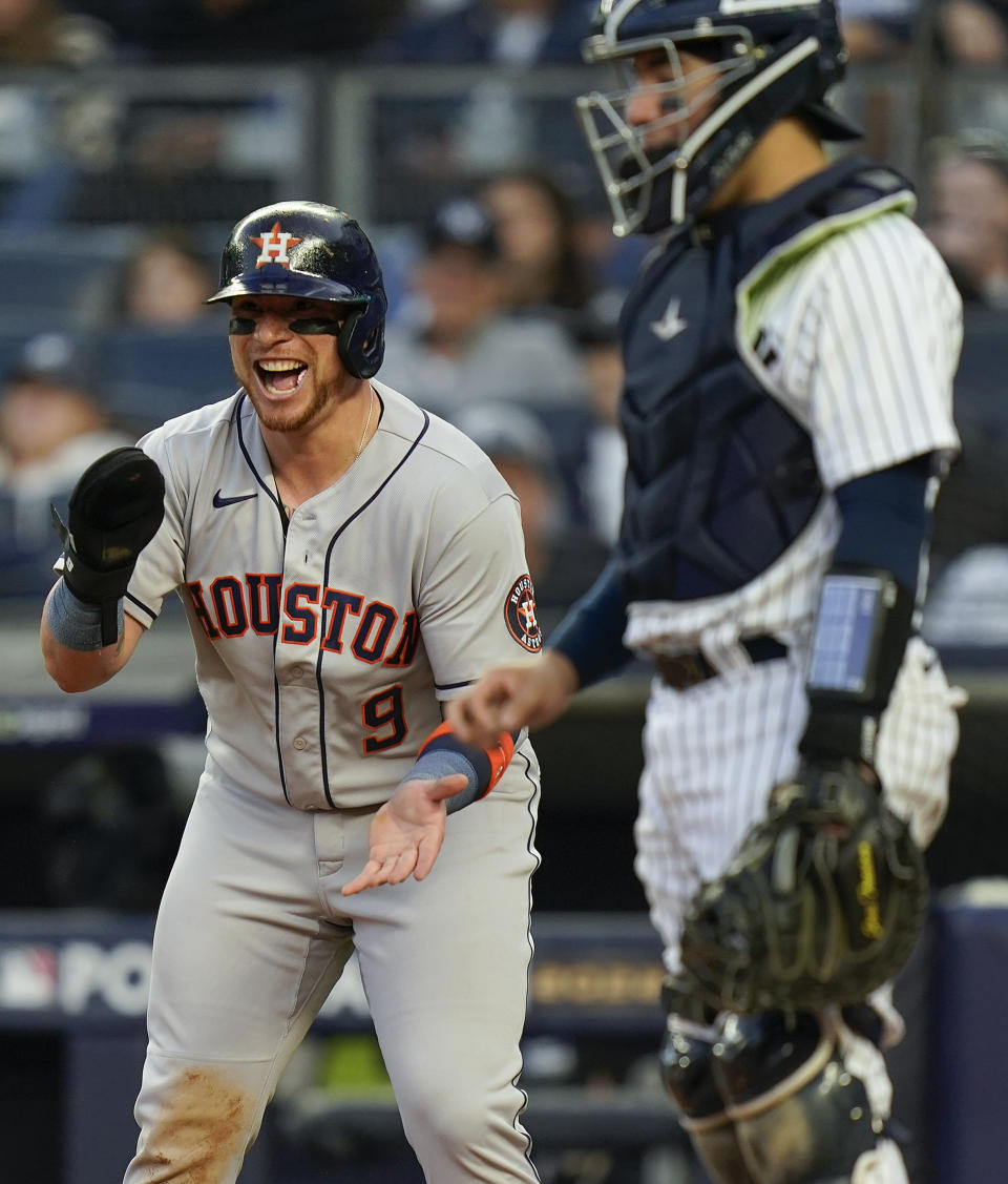 Houston catcher Christian Vazquez (9) reacts at home plate as Chas McCormick rounds the bases after hitting a two-run home run against the New York Yankees during the second inning to of Game 3 of an American League Championship baseball series, Saturday, Oct. 22, 2022, in New York. (AP Photo/Seth Wenig)