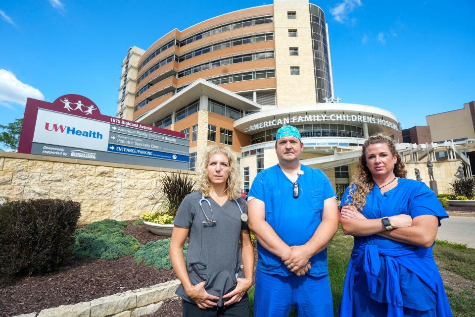 From left, Shari Signer, who works in the infusion center, Zach Sielaff, pediatric operating room nurse, and Mary Jorgensen, operating room nurse, pose for a portrait on Aug. 23, 2022, in front of American Family Children's Hospital in Madison. Jorgensen has been working at this location for 17 years, Signer for 19 years and Sielaff for nine months. Nurses are set to strike in an effort to form a union. "I'm 100% ready to strike," Signer said.