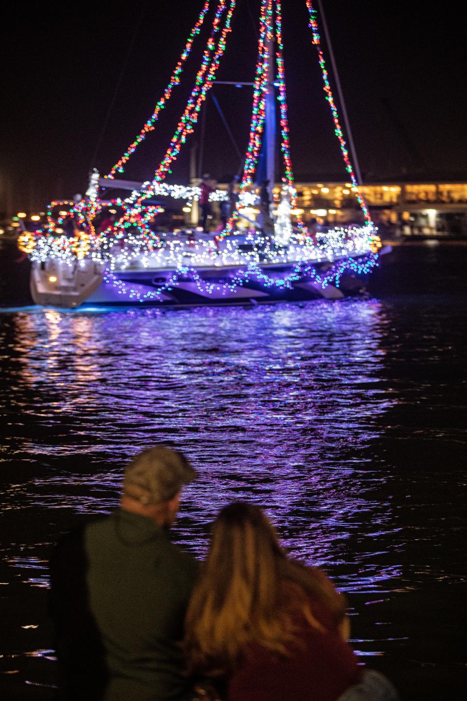 Vessels showing off Christmas light displays loop around the Corpus Christi Marina for the Illuminated Boat Parade on Saturday, Dec. 4, 2021.