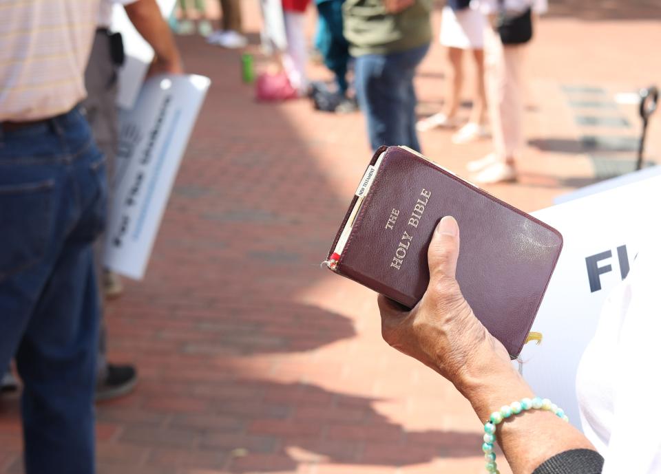 A woman holds a Bible at a pro-life rally in front of the steps of the Historic Capitol on Tuesday, May 24, 2022.