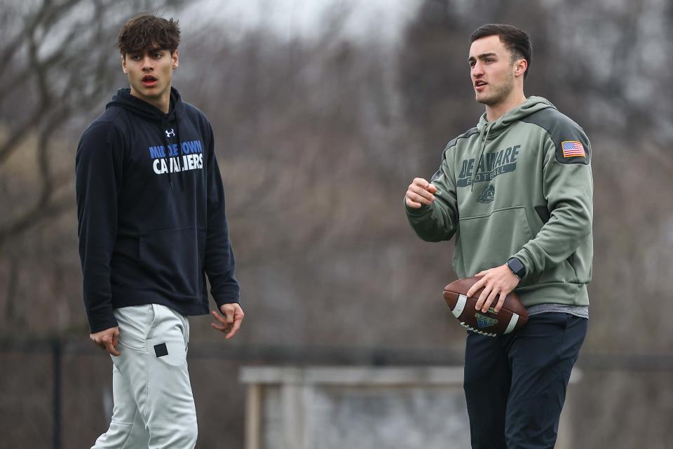 Former Smyrna High and University of Delaware Quarterback Nolan Henderson (right) stands with Middletown quarterback Austin Troyer (left) during a quarterbacks training session on Sunday, February 11, 2024 at Red Lion Christian Academy turf field in Bear.