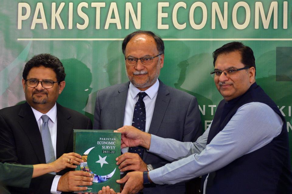 Pakistan's Finance Minister Miftah Ismail (L), Minister for Planning and Development Ahsan Iqbal (C) and Secretary Finance Hamed Yaqoob Sheikh display the 'Economy Survey 2021-22' during its launch ceremony in Islamabad, June 9, 2022. / Credit: FAROOQ NAEEM/AFP/Getty