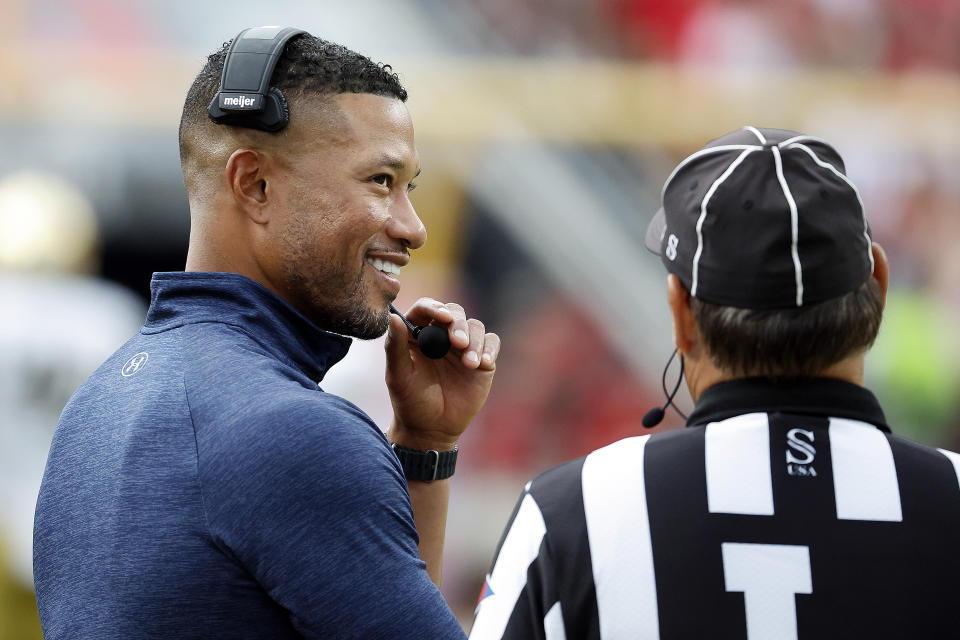 Notre Dame head coach Marcus Freeman speaks with an official prior to a weather delay during the first half of an NCAA college football game against North Carolina State in Raleigh, N.C., Saturday, Sept. 9, 2023. (AP Photo/Karl B DeBlaker)