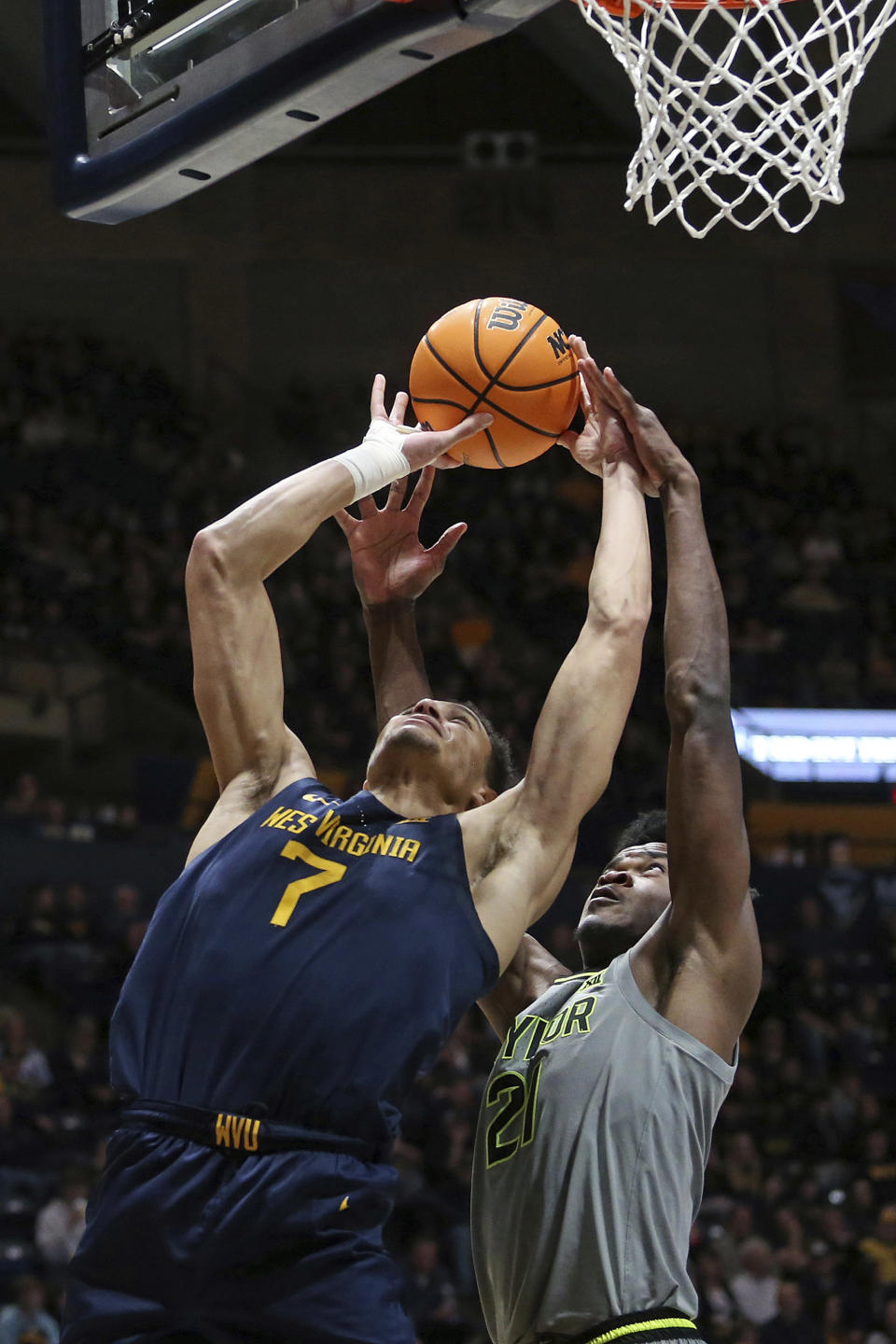 West Virginia center Jesse Edwards (7) is defended by Baylor center Yves Missi (21) during the second half of an NCAA college basketball game Saturday, Feb. 17, 2024, in Morgantown, W.Va. (AP Photo/Kathleen Batten)