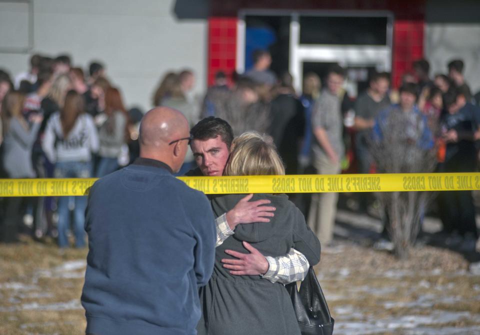 Students gather and reunite with their families at a fast food joint across from Arapahoe High School, after a student opened fire in the school in Centennial, Colorado