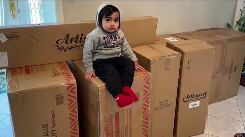 Ayaansh Kumar sits on some on boxes containing some of the furniture he ordered from Walmart.com. (Pramod Kumar)