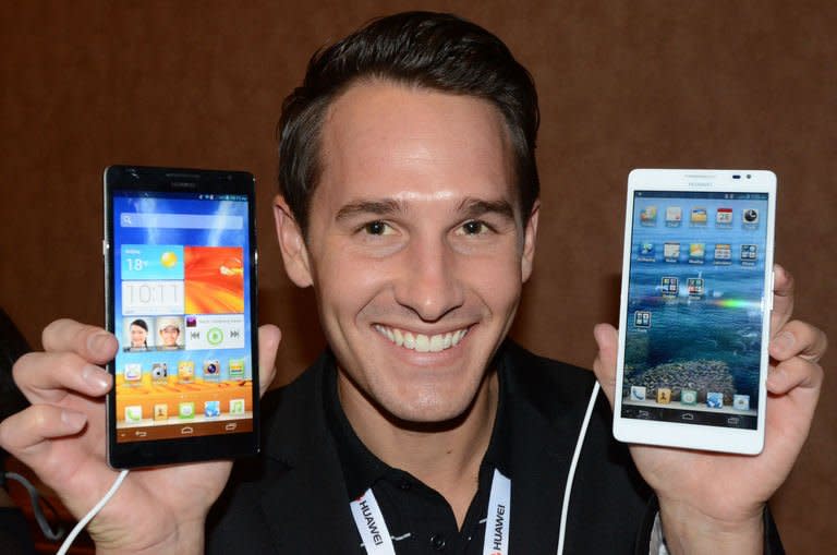 Huawei production specialist Scott Murphy shows soon-to-be released new smartphones Huawei Ascend Mate at the 2013 International Consumer Electronics Show in Las Vegas on January 7, 2013