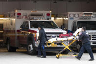 Emergency Medical Technicians wheel a collapsible wheeled stretcher into the emergency room at NewYork-Presbyterian Lower Manhattan Hospital, Wednesday, March 18, 2020, in New York. "Do not go to the emergency room unless it is a true, immediate and urgent emergency," said Mayor Bill de Blasio, who pleaded Tuesday with people who suspect they have coronavirus symptoms to stay home and see if they improve in a few days before even calling a doctor. For most people, the new coronavirus causes only mild or moderate symptoms. For some it can cause more severe illness. (AP Photo/Mary Altaffer)