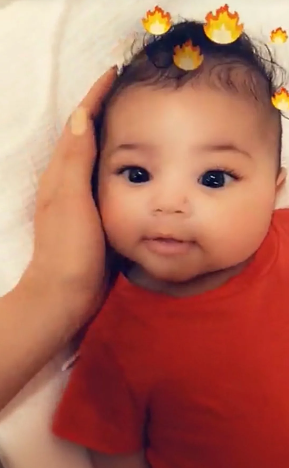 She can be seen affectionately cradling her baby's head. Source: Snapchat/KylieJenner