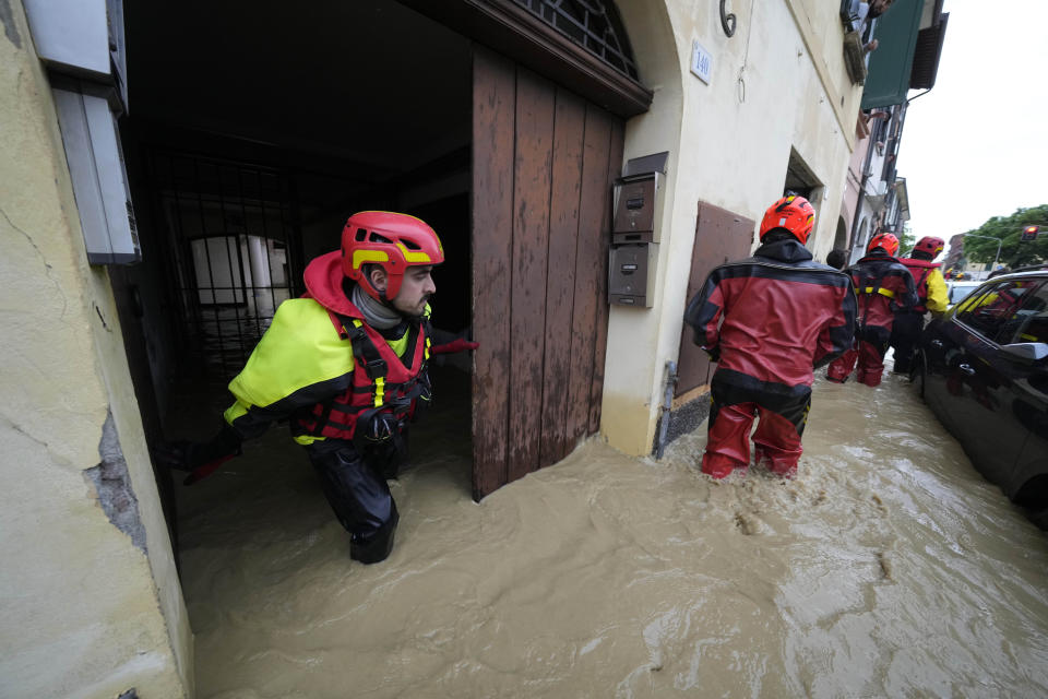 Rescuers checks buildings in the flooded village of Castel Bolognese, Italy, Wednesday, May 17, 2023. Exceptional rains Wednesday in a drought-struck region of northern Italy swelled rivers over their banks, killing at least eight people, forcing the evacuation of thousands and prompting officials to warn that Italy needs a national plan to combat climate change-induced flooding. (AP Photo/Luca Bruno)