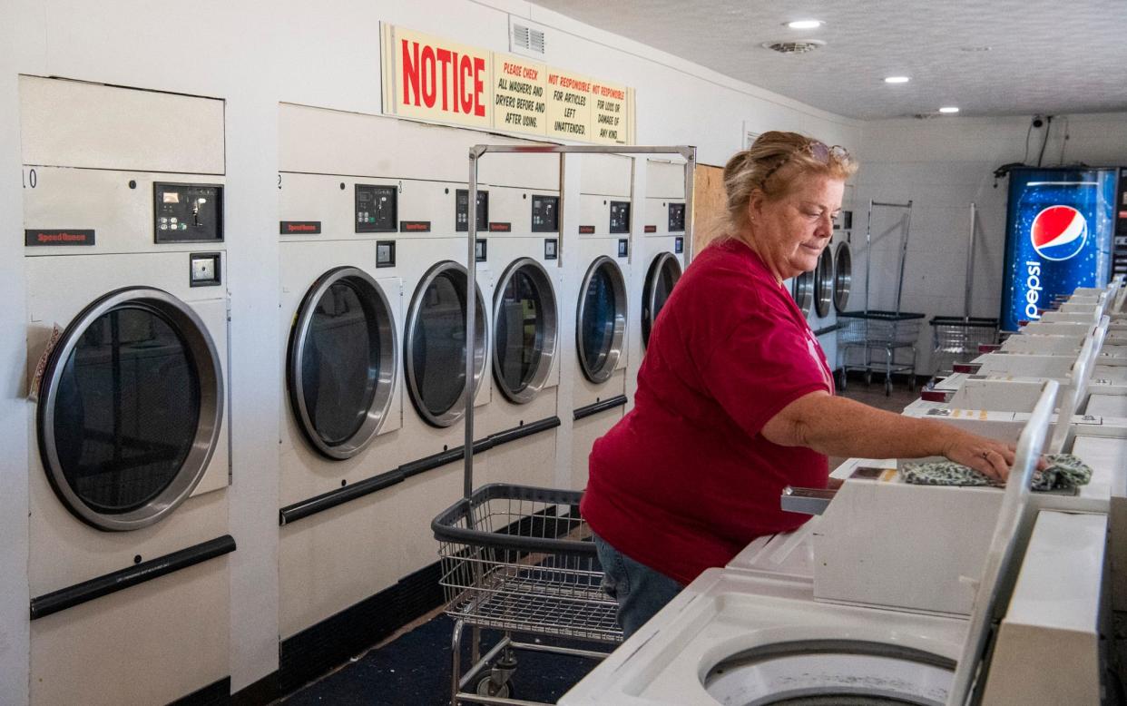 Cindy Marker cleans inside the Crystal Clean Laundromat in Gosport on Wednesday, Nov. 15, 2023.