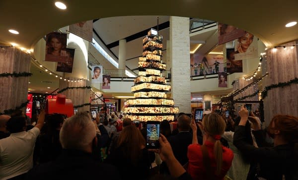 Mall of the Emirates visitors watch as the mall's carbon neutral LED tree showcases an impactful display centred around climate change and sustainability