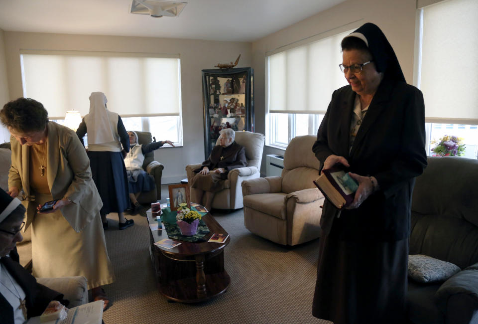 Nuns of the Felician Sisters of North America conclude morning prayers at St. Anne Home in Greensburg, Pa., on Thursday, March 25, 2021. Last October the nuns lost one of their own, Sister Mary Evelyn Labik, to the coronavirus. (AP Photo/Jessie Wardarski)