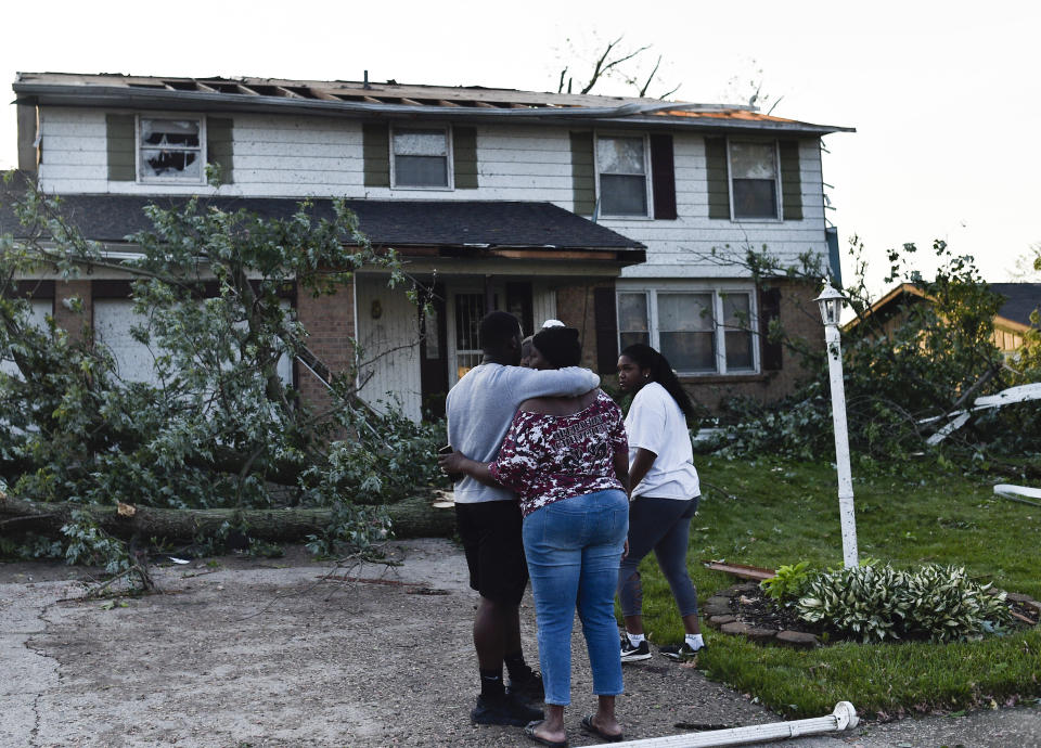 Residents of the West Brook neighborhood of Trotwood, Ohio, inspect the damage to their homes following powerful tornadoes on May 28. 