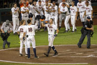 Virginia Chris Newell (9) celebrates his homer in the fifth inning with Logan Michaels (12) and Zack Gelof (18) against Texas during a baseball game in the College World Series Thursday, June 24, 2021, at TD Ameritrade Park in Omaha, Neb. (AP Photo/John Peterson)